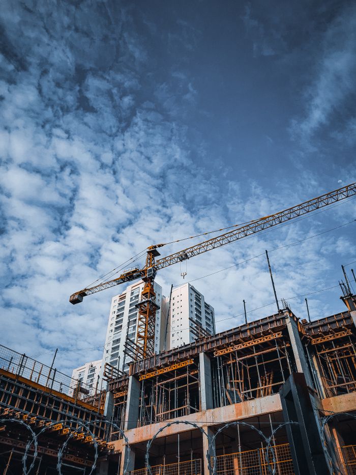 Low angle view of a construction site and crane under a blue sky in São Paulo, Brazil.